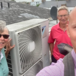 3 people on rooftop by heat pump