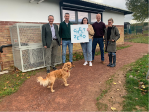 group of people and dog by a heat pump