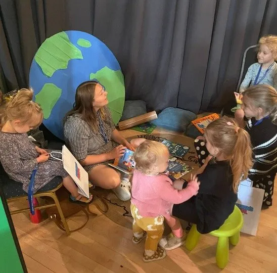 Group of parents and child by a picture of the planet